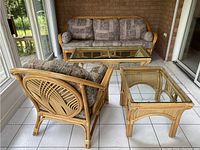 Three-seater sofa with cushions, accent chair with cushions, coffee table and side table with glass tops