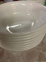 Stack of eight white bowls showing interior and shape