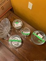 Assorted crystal bowls and bud vase with intricate cut details and leaf/star patterns