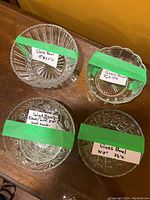 Four assorted clear glass serving bowls shown from above with size labels