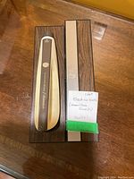 Side view of Hamilton Beach electric knife in closed case with handwritten note stating 'Electric knife (Hamilton Beach) works!'