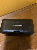 Closed black Hamilton Beach branded carrying case for electric cutting knife.