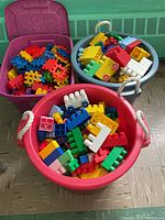 Three bins of assorted Mega Building Blocks in various colors and shapes, showing the overall contents of the lot.