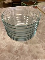 Side view of stacked clear glass bowls showing smooth edges and transparency.