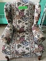 Front view showing floral wing back chair upholstery and shape.