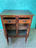 Front view of the wooden cabinet with two drawers open and double doors open showing interior storage space.