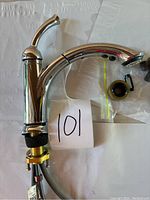 Complete kitchen faucet assembly with single handle and pull-out sprayer with chrome finish.