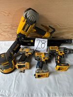 Overview of all five Dewalt tools including cordless nailer, drills, impact driver and sander with visible wear and missing batteries.
