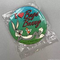 Front of the button pin showing Bugs Bunny, green background, and 'I Love Bugs Bunny' text.