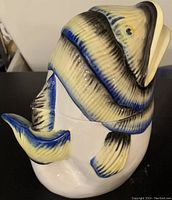 Side profile of the fish-shaped cookie jar showing detailed ceramic painting in multiple colors.