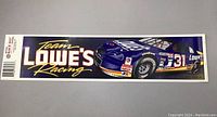 Photo of a rectangular Lowes Team Racing sticker with a blue race car number 31 on right side and text 'Team Lowes Racing' on left side.