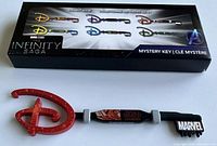 Photo showing the Marvel Studios Infinity Saga collector key with packaging displaying all six collectible mystery keys in the series.