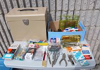 Overview of all office supplies and beige filing cabinet shown on a gray table