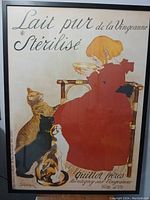 Full view of the framed poster showing the girl in red with four cats and the French promotional text.