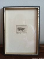 Photo showing the full framed etching mounted on white matting with a simple frame.