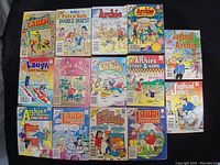 Photo showing the front covers of 17 vintage Archie comic books and digest magazines arranged in 3 rows, featuring Laugh Digest Magazine, Pals 'n' Gals Double Digest, Jughead & Archie, and various Archie comics.