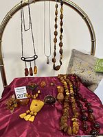 Overall view of necklaces hanging and pouch