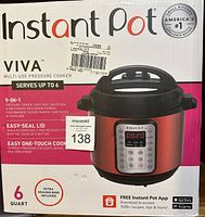Front and partial side view of boxed Instant Pot Viva Multi-Use Pressure Cooker showing brand, model, features and capacity details.