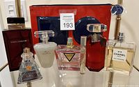 Full lot showing six perfumes and the red cosmetic bag