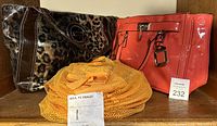 Photo showing two purses and orange IKEA PS FÅNGST mesh organizer. Eliz Grant cheetah print purse and salmon patent leather Le Chateau purse are visible.