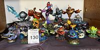 Photo of 20 various Skylanders figures arranged on a surface showing full lot.