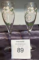 Pair of vintage hand painted Perrier & Jouet champagne flutes side by side showing floral designs.