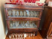 Frontal view of two-shelf barrister bookcase filled with glassware