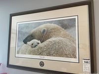 Full view of the framed print showing a mother polar bear and cub, title and art seal visible, wood frame and glass front.