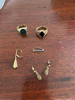 Overview of all six jewelry pieces arranged on wooden surface