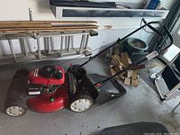 Full side view of mower on garage floor