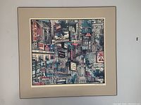 Framed colorful detailed print showing a collage of Toronto landmarks and signs including Massey Hall, Royal Alexandra Theatre, SkyDome, and Maple Leaf Gardens.