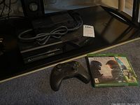 Overall view showing console, controller, games and power cable