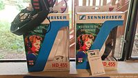 Two boxes of Sennheiser HD 455 headphones with one pair of headphones displayed on left box.