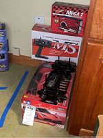 Photo showing the Tamiya RC Ferrari chassis and the boxes for the remote control system and charger.