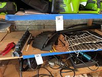 Shelf with organized metric and American wrenches in rolls, poly pipe pinch clamp tool, and Allen wrench roll.