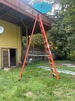Full view of ladder set up in A-frame position outdoors