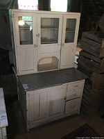 Full front view of two-piece cabinet showing glass-front hutch and base