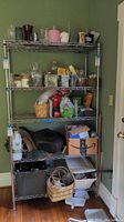 Full view of the metal wire shelving unit filled with various household items to show shelving structure and size.