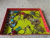Tray containing multiple sterling silver necklaces, pendants and a brooch