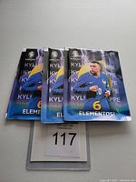 Three unopened UEFA Euro 2024 soccer card packs with Kylian Mbappé on the front.