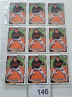 Front view of 9 Gunnar Henderson Bowman baseball cards in protective sleeves, showing the player in Orioles black jersey and baseball pants, holding a baseball glove.