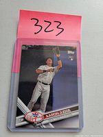 Front side of Aaron Judge Topps rookie baseball card in protective case showing player image and Topps rookie emblem.