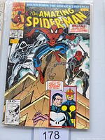 Front cover of Amazing Spiderman #356 comic book in protective plastic sleeve. Shows Spiderman, two other characters, comic title and front cover details.