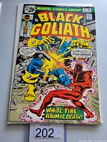 Front cover of Black Goliath #2 vintage Marvel comic book showing colorful action scene between Black Goliath and a red villain along with text and logos.