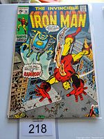 Front cover of the Iron Man #36 comic book in plastic sleeve, showing Iron Man fighting Ramrod in a city scene.