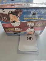 Photo showing sealed front side of box with NHL player images and Upper Deck branding.