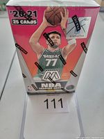 Front view of the sealed 2020-21 Panini Mosaic basketball cereal box featuring Luka Dončić image and seal tape.