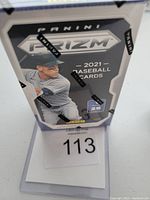 Front view of the sealed 2021 Panini Prizm Baseball cereal box showing branding and image of a player.