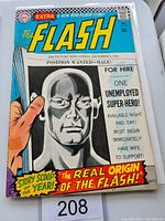 Front cover of The Flash #167 comic book showing The Flash holding a newspaper with a grayscale man and headline about a superhero job.