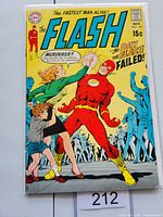 Front cover of The Flash #192 comic book showing The Flash in red costume, a woman and child in the foreground, and blue-tinted figures in the background with story title 'The Day the Flash Failed'.